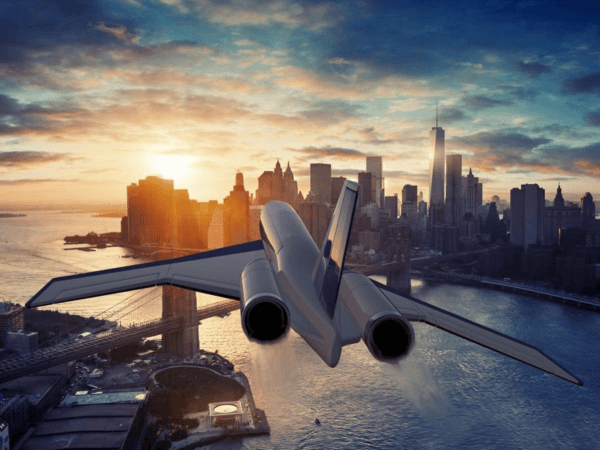 A faster airplane flying over a city at sunset.