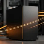 Black computer tower with glowing orange power cables on a server room floor.