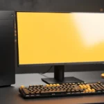 Desktop computer setup with black tower, monitor displaying yellow screen, keyboard with gold accents, mouse, and decorative