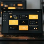 Laptop displaying a dark-themed design application with yellow and orange UI component cards and icons.