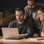 Three colleagues viewing a laptop at a desk with overlaid golden digital interface graphics.