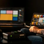 Video editor reviewing colour palette and image gallery on tablet whilst working at dual-monitor editing workstation.